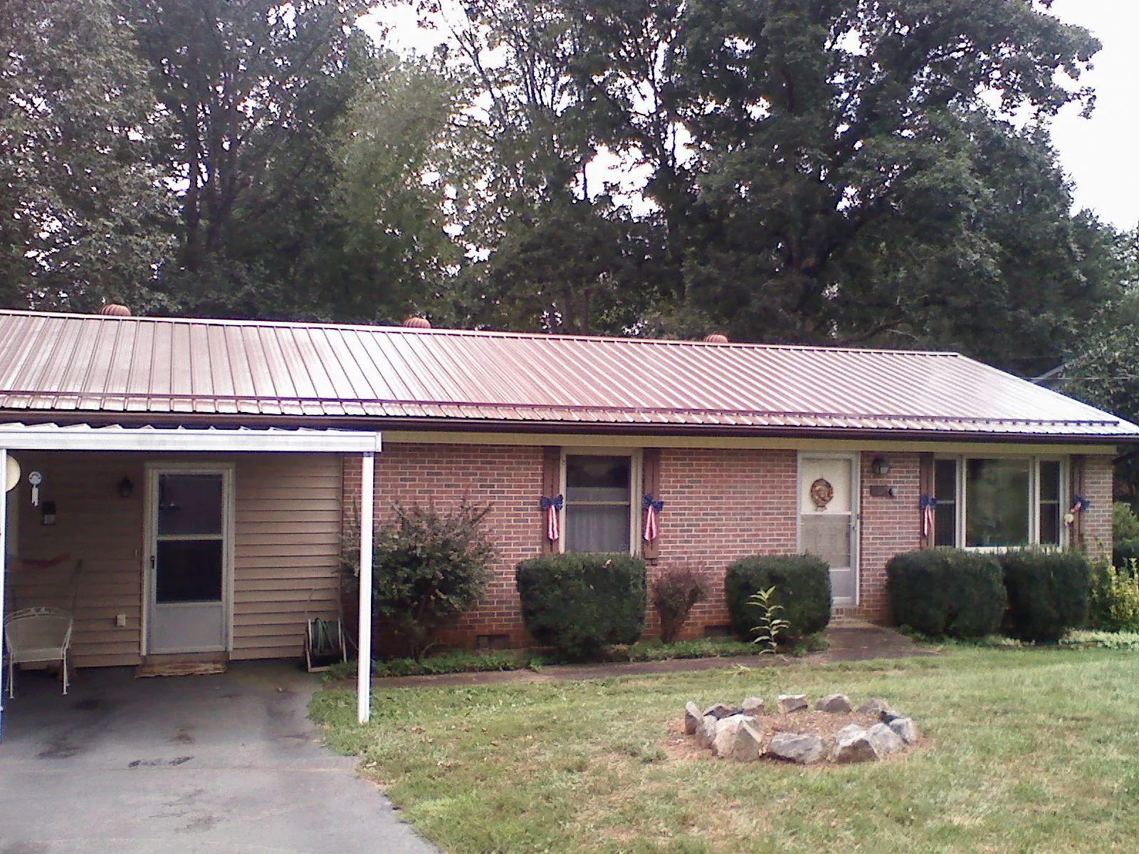 Bronze metal roof and carport on a brick ranch home — Roof Repair work by our crew in Green Pond