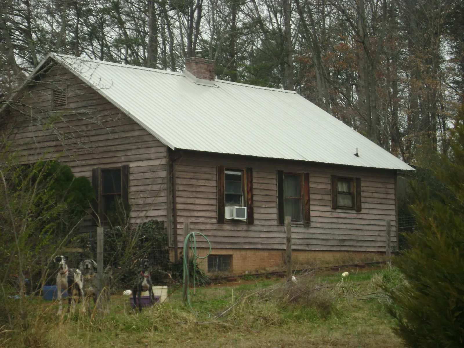 White metal roof on an old wood sided farmhouse, from a Metal Roof Installation job in Green Pond